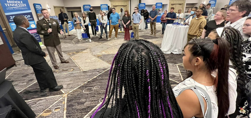 As MTSU President Sidney A. McPhee, left, listens, U.S. Army Lt. Col. Arlin Wilsher, second from left, talks with Birmingham, Ala., students attending the MTSU True Blue Tour recruiting event recently. Wilsher heads the MTSU Military Science Department. (MTSU photo by Andrew Oppmann)