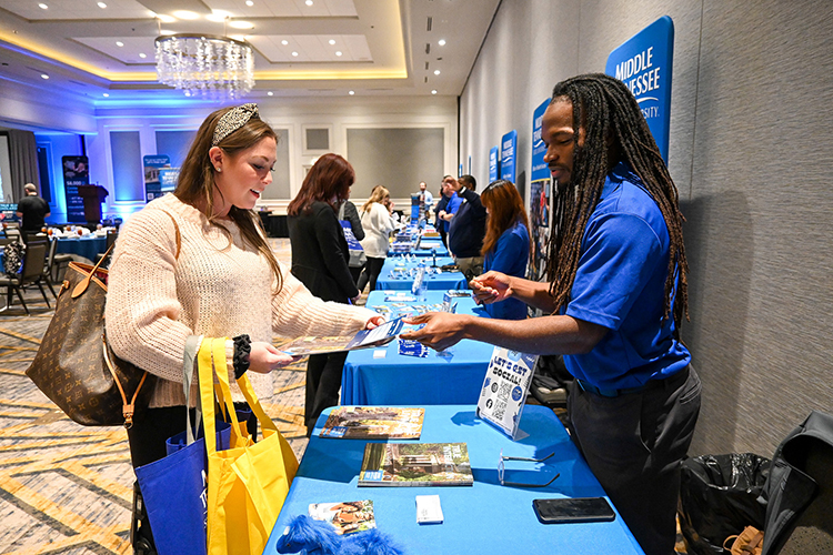 A high school counselor attends the Middle Tennessee State University True Blue Tour event at the Cool Springs Marriott in Franklin, Tenn., on Monday, Nov. 14, 2022, stopping by one of the tables to learn more about all the Blue Raider campus has to offer. (MTSU photo by Stephanie Wagner)