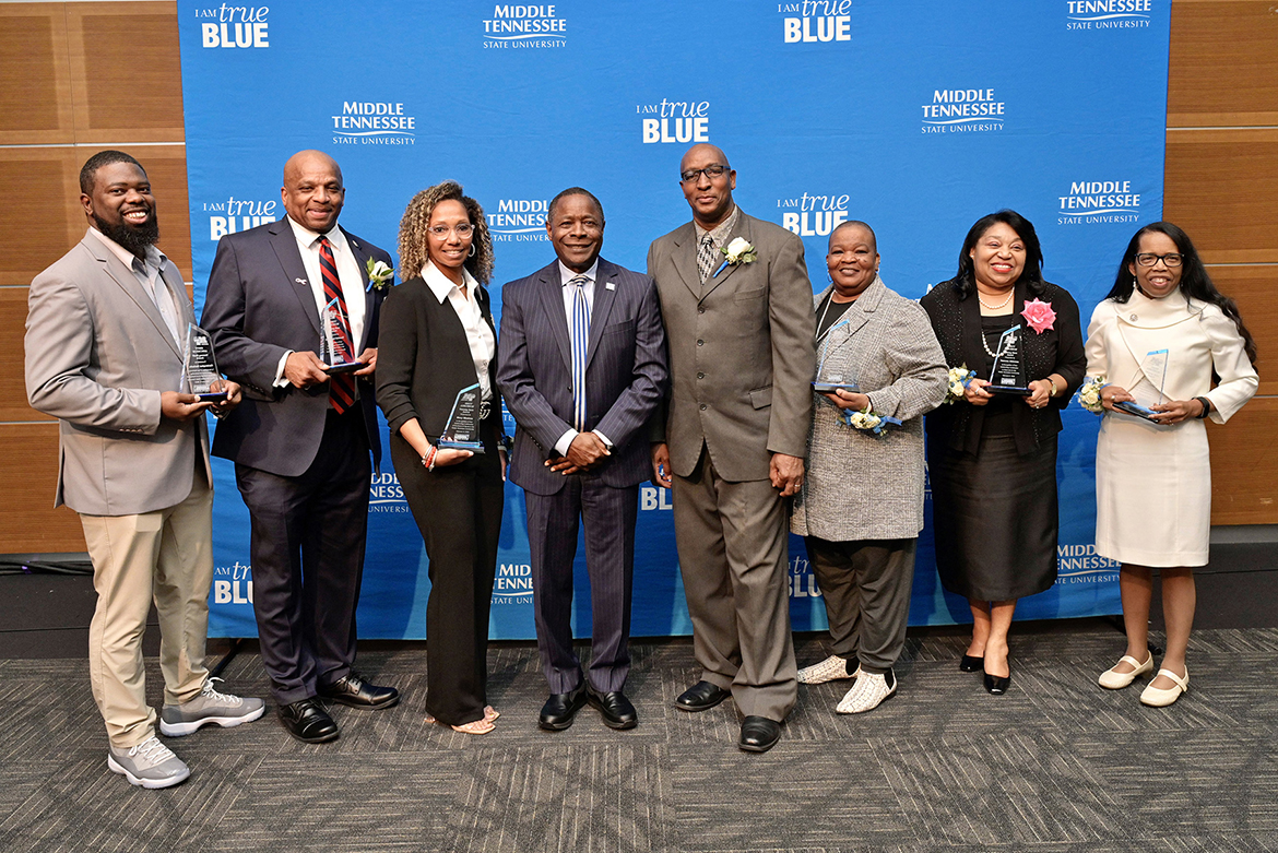 Middle Tennessee State University President Sidney A. McPhee, fourth from left, joined the university in honoring seven “unsung heroes” during the 27th annual Unity Luncheon held Wednesday, Feb. 8, at the Student Union Building. Pictured, from left, are honorees Christopher Rochelle; Michael McDonald; Stacy Windrow; McPhee; Joe and Sybil Rich; Vanessa Alderson; and Marva Lucas. (MTSU photo by Andy Heidt)