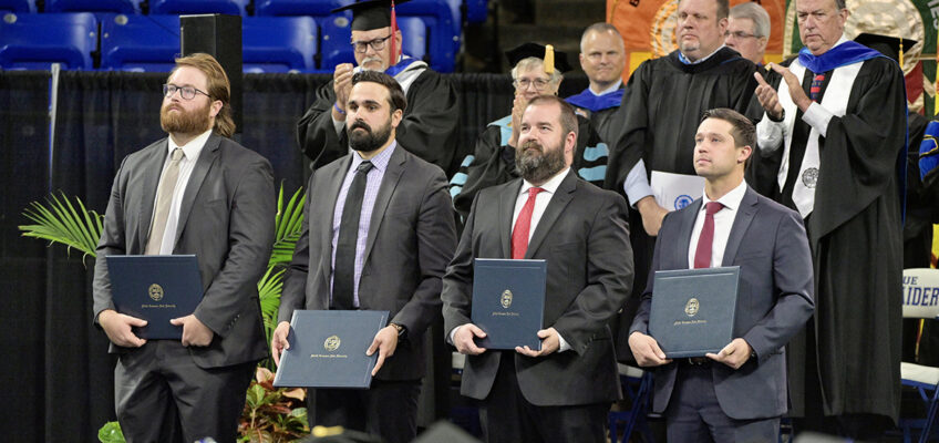 From left, Metro Nashville Police Department detective Ryan Cagle, detective Zachary Plese, Sgt. Jeffrey Mathes and detective Michael Collazo hold their honorary professorship in public safety certificates presented to them at the university’s spring commencement ceremony Friday, May 5, in Murfreesboro, Tenn. A total of five officers received the honor for their heroic response to the Covenant School shooting in Nashville, Tenn., in late March. Officer Rex Engelbert was unable to attend the ceremony. (MTSU photo by Andy Heidt)