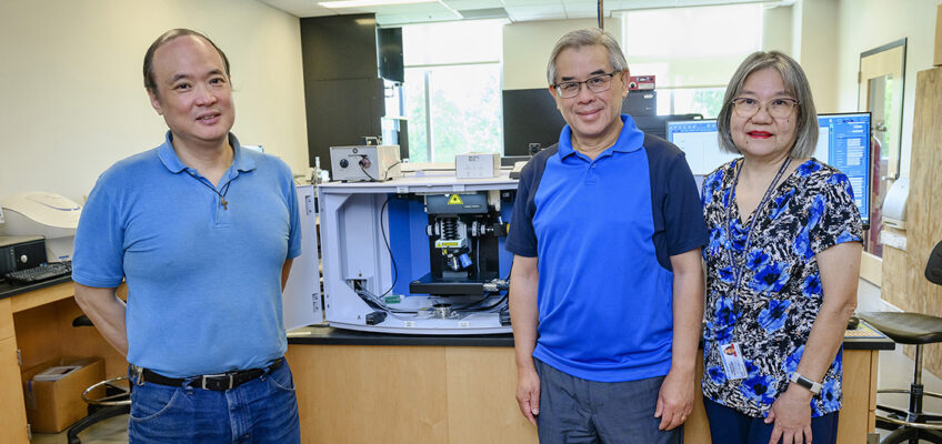 Middle Tennessee State University chemistry faculty, from left, Charles Chusuei, Sing Chong and Beng Guat Ooi are shown Thursday, Aug. 18, at the Science Building on campus in front of a specialized Raman confocal microscope, one of the department’s four recently acquired, cutting-edge pieces of chemistry instrumentation that they hope will expand research and hands-on experience opportunities for faculty and students. (MTSU photo by J. Intintoli)