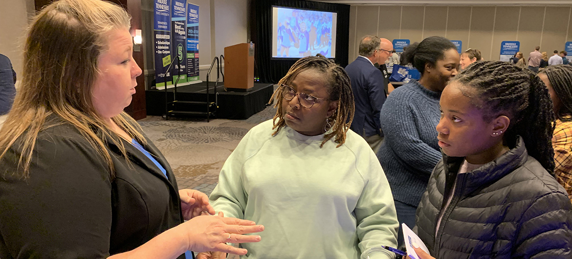 Becca Smitty, left, MT One Stop director at Middle Tennessee State University, reviews academic programs and options with mother and daughter Darice and Leah Townsend of Hazel Green, Ala., during the recent MTSU True Blue Tour event at The Westin in Huntsville, Ala. The Huntsville stop completed the 14-city fall recruiting tour. (MTSU photo by Randy Weiler)