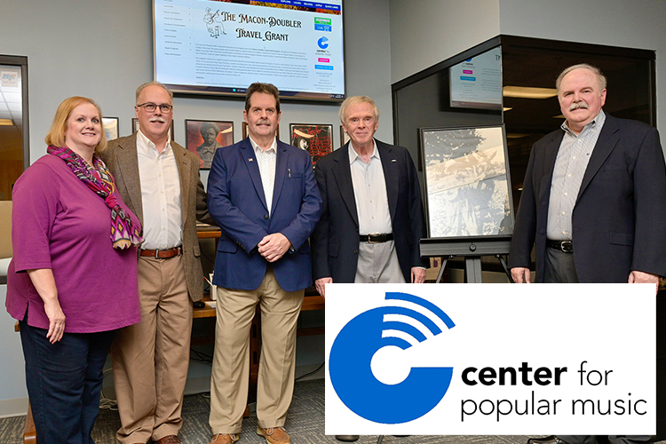 Family members of Uncle Dave Macon, the first Grand Ole Opry superstar, stand in the Center for Popular Music at Middle Tennessee State after their Macon-Doubler Fellowship nonprofit donated $5,000 to fund travel grants to research the life and legacy of their great-grandfather. Gathered at the center are, from left, Katie Doubler Steuart, John Doubler, Paul Doubler, Bernie Doubler and Mike Doubler. (MTSU photo by Andy Heidt)