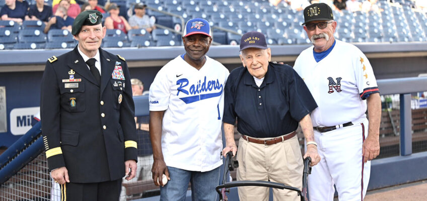From left, retired Army Lt. Gen. Keith Huber, senior adviser for veterans and leadership initiatives at Middle Tennessee State University; MTSU President Sidney A. McPhee; World War II Navy veteran and D-Day survivor Bill Allen, of Murfreesboro, Tenn.; and Nashville Sounds Manager Rick Sweet gather for a photo before the Sounds’ special Military Appreciation Night game Thursday, June 6, at First Horizon Park in Nashville, Tenn. Allen, 99, was a special guest for the game, which was also True Blue Night at the Sounds. Sweet is wearing a special military-themed jersey that Sounds players wore and are being auctioned to benefit MTSU’s Charlie and Hazel Daniels Veterans and Military Family Center. (MTSU photo by James Cessna)
