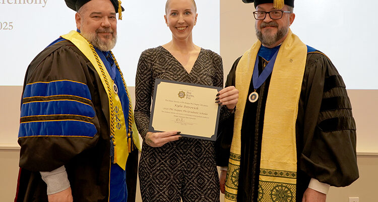 Middle Tennessee State University Vice Provost for Research Dean of Graduate Studies David Butler, left, and Phi Kappa Phi Chapter 246 President Philip E. Phillips, right, present the Graduate Scholar Award certificate to English doctoral student Kylie Petrovich at the Spring 2025 Phi Kappa Phi Initiation ceremony on the MTSU campus in Murfreesboro, Tenn.. (MTSU photo by Robin Lee)