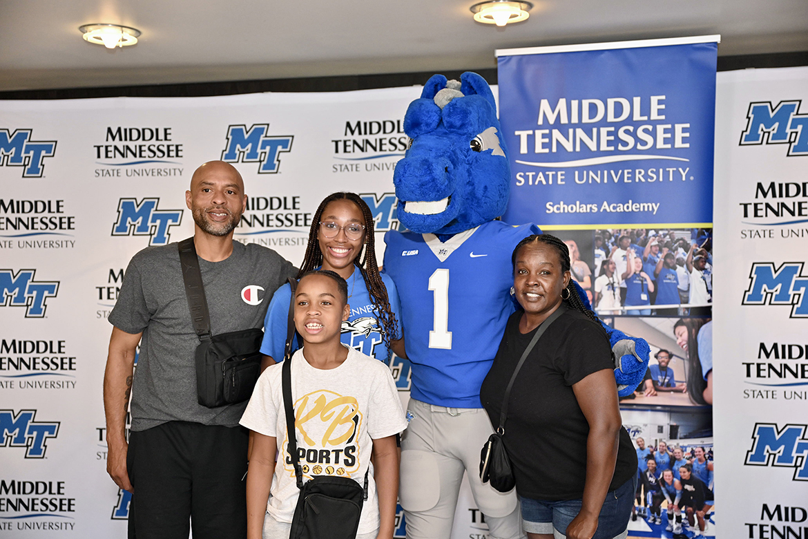 Middle Tennessee State University mascot Lightning, second from right, mingles with a family dropping off their daughter, Amaya Harris, to MTSU and its Scholars Academy program on Sunday, Aug. 10, at Tucker Theatre on the MTSU campus in Murfreesboro, Tenn. (MTSU photo by James Cessna)
