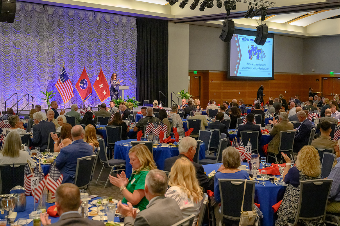 More than 200 people attending the eighth annual Charlie and Hazel Daniels Veterans and Military Family Center’s Veteran Impact Celebration in the Middle Tennessee State University Student Union Ballroom listen as alumna and WSMV-TV News 4 morning co-anchor and alumna Holly Thompson provides a welcome and instructions for the evening’s activities at the mid-August event on campus in Murfreesboro, Tenn. (MTSU photo by J. Intintoli)