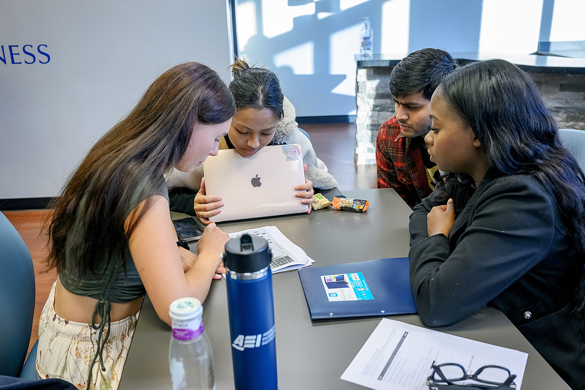 From left, Middle Tennessee State University students Masha Bystritskii, Sayuri Shrestha, Kris Patel and Kendahl Franklin review data as part of “The Call of Data” 24-hour analytics challenge held Nov. 7-8 inside the Business and Aerospace Building on campus in Murfreesboro, Tenn. The group captured first place, earning them a $1,500 scholarship. (MTSU photo by Andy Heidt)