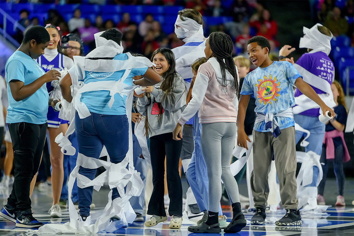 Hobgood Elementary School students took home the win for winding the most toilet paper around a teacher during a competition during the annual Murfreesboro City Schools’ Education Day game held Monday, Nov. 3, in Murphy Center on the Middle Tennessee State University campus in Murfreesboro, Tenn. (MTSU photo by Andy Heidt)