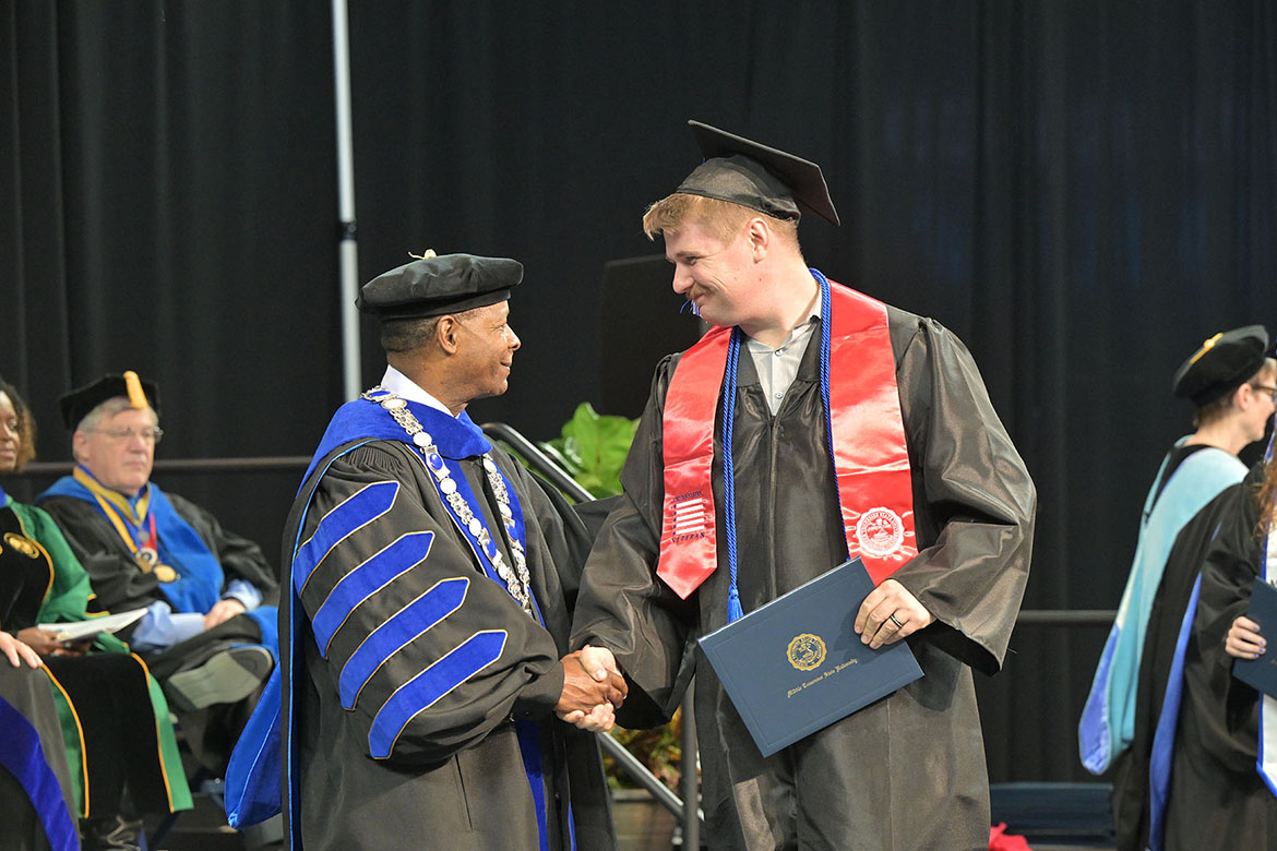 Middle Tennessee State University President Sidney A. McPhee shakes the hand of a student-veteran graduate during the fall 2025 morning commencement ceremony held Saturday, Dec. 13, inside Murphy Center on campus in Murfreesboro, Tenn. (MTSU photo by James Cessna)