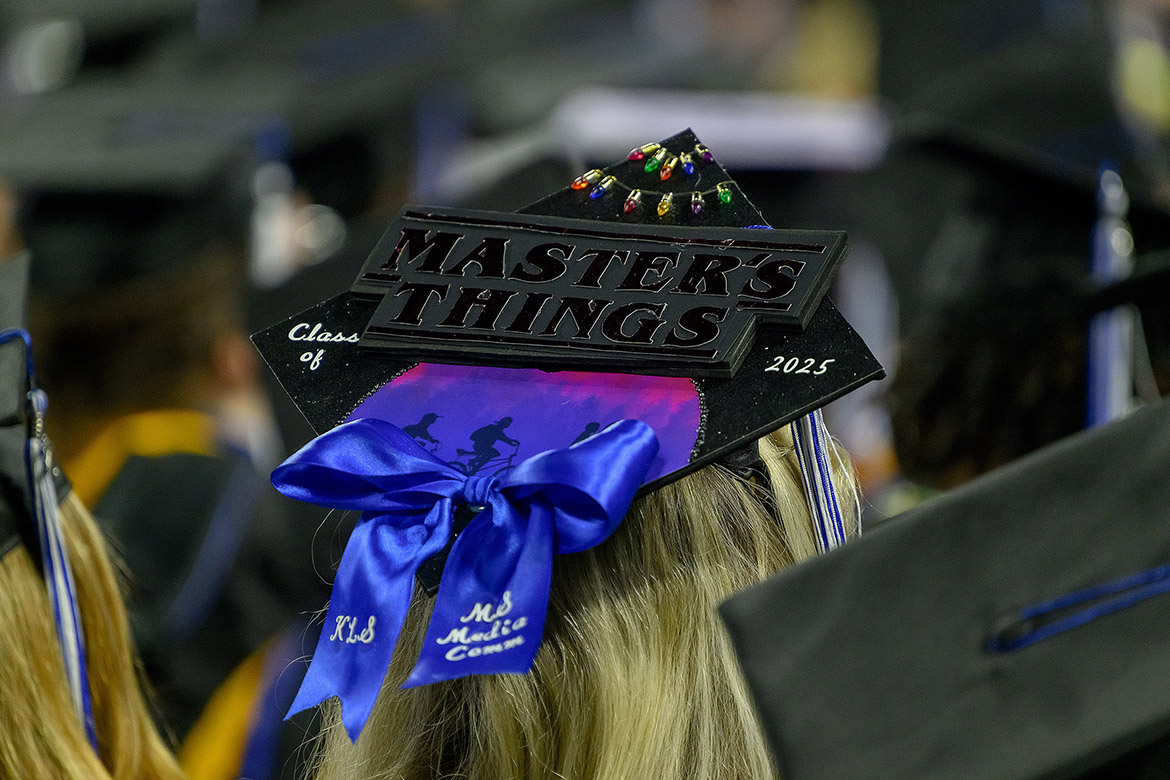 Middle Tennessee State University graduate Karli Sutton wears her “Stranger Things”-themed mortarboard she decorated as a nod to her master’s degree thesis during the fall 2025 afternoon commencement ceremony held Saturday, Dec. 13, inside Murphy Center on campus in Murfreesboro, Tenn. (MTSU photo by Andy Heidt)
