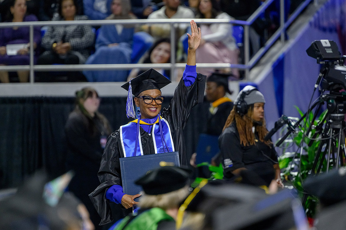 Middle Tennessee State University graduate Johari Hamilton waves to family during the fall 2025 afternoon commencement ceremony that conferred degrees for more than 1,600 Blue Raiders in two ceremonies on Saturday, Dec. 13, inside Murphy Center on campus in Murfreesboro, Tenn. (MTSU photo by Andy Heidt)