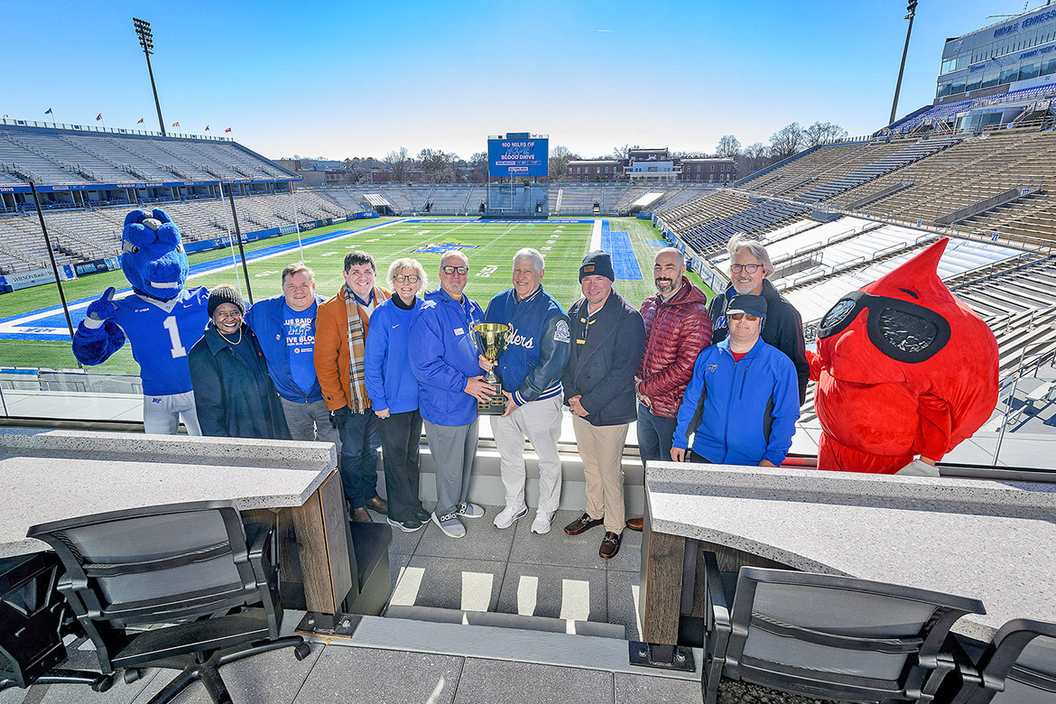 Middle Tennessee State University retained the challenge trophy to top Conference USA rival Western Kentucky University by nearly 90 units of donated blood for the annual “Bleed Blue to Beat WKU” blood drive, formerly “100 Miles of Hope,” held Oct. 27-29 at each respective school. Red Cross representatives and board members and MTSU staff present for the presentation of the trophy are, from left, MTSU mascot Lightning, board member, alumna and Dean Emeritus Gloria Bonner; John Mitchell, Heart of Tennessee Red Cross executive director; Justin Reed, director MT Unions; Diane Turnham, MTSU deputy athletic director; Gene Baker, senior account manager of Donor Services for Red Cross of Tennessee; Chris Massaro, MTSU athletic director; board member Kevin Fehr, Amada Senior Care; board member Josh Stone, director of Campus Recreation; board member Roy Boyd with son, Adam Boyd; and Red Cross mascot Buddy Blood Drop. (MTSU photo by Andy Heidt)