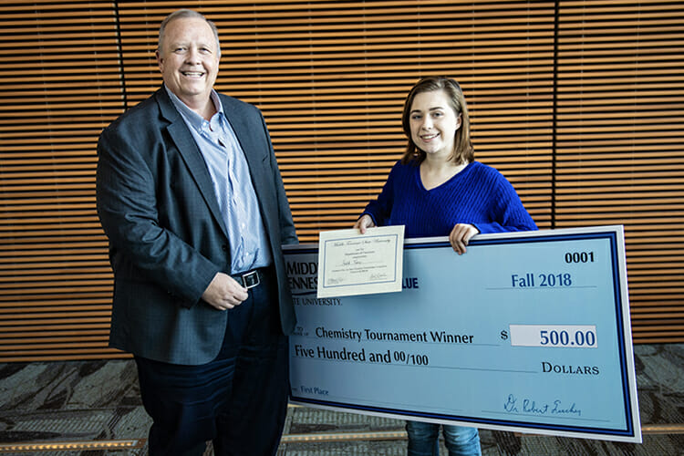 MTSU College of Basic and Applied Sciences Dean Bud Fischer, left, presents Faith Viers of Central Magnet School in Murfreesboro with a $2,000 scholarship to attend MTSU and $500 for earning first place honors in the Nov. 26 Chemistry Scholarship Tournament in the Science Building. (MTSU photo by Eric Sutton)