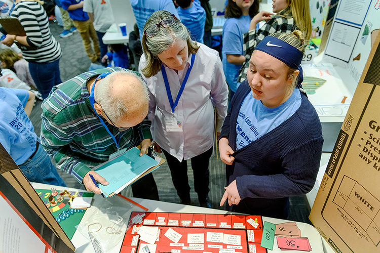 “Electrical Connector” game inventor Avery Sellars, right, from Winfree Bryant Middle School in Lebanon, Tenn., explains her plan to judges Bob Hughes, left, and Sara Simmons Feb. 21 at MTSU’s 27th annual Invention Convention. Avery’s invention won a ribbon as a “Judges’ Favorite” in the Sixth Grade Games category. (MTSU photo by J. Intintoli)