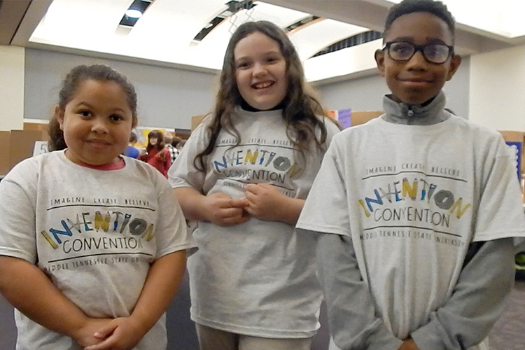 A trio of innovators from Murfreesboro’s Mitchell-Neilson Elementary School discuss their “Keep Calm & Cool Basketball Game” at MTSU's 27th annual Invention Convention, held Feb. 21 in the university's Student Union Ballroom. From left are fourth-grader Keeley Vaughn, fifth-grader Breanna Nolen and fourth-grader Malaki Frierson, who found their inspiration in sports and a special person in their lives. The three were among nearly 800 Midstate youngsters attending this year's event, displaying a total of 375 inventions. (MTSU photo by News and Media Relations)