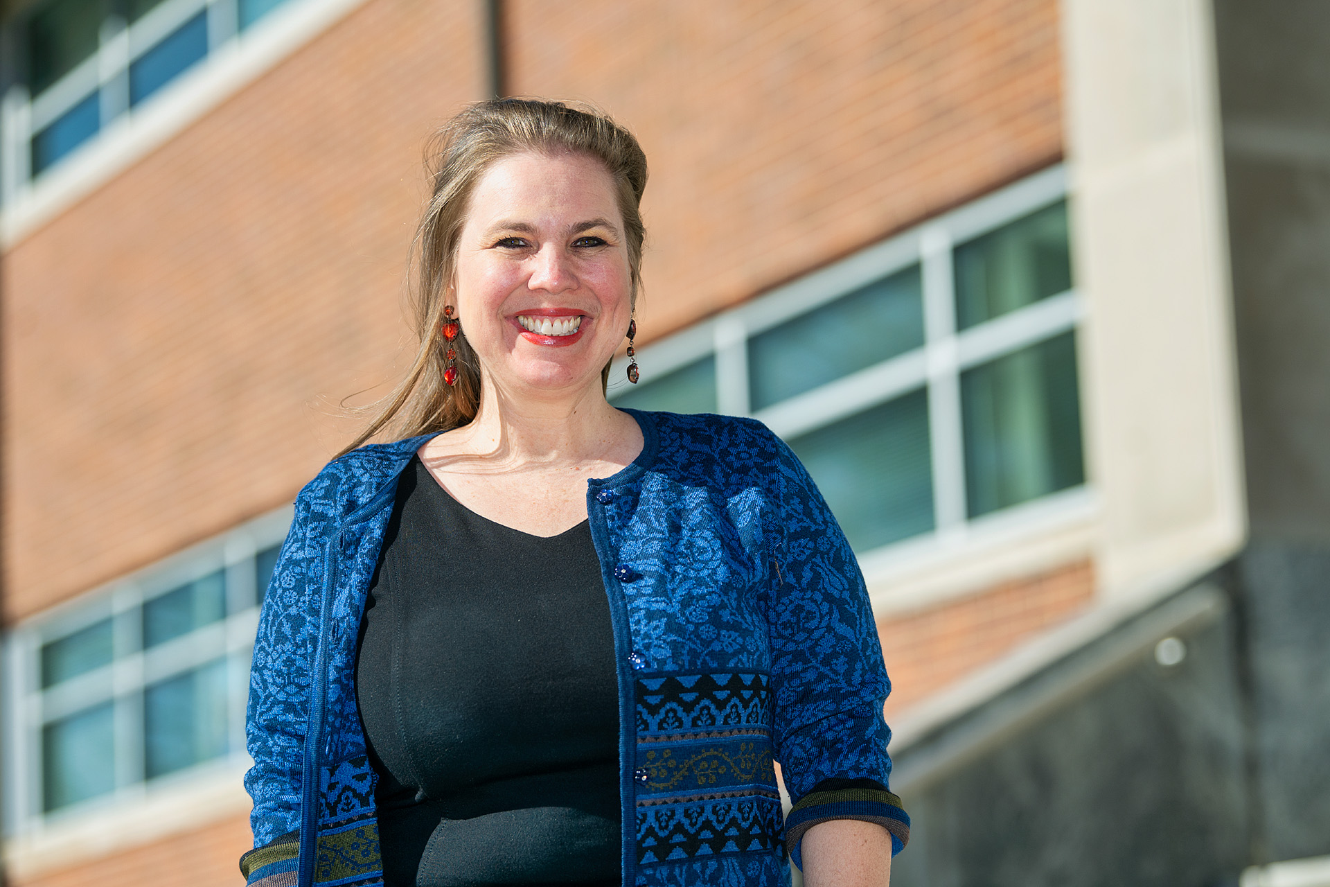MTSU art education professor Debrah Sickler-Voigt pauses for a photo outside Todd Hall Thursday, Nov. 19, after checking in on her students who were inspecting, touching up and adding mosaics to the "Be the Missing Piece" arts and sciences project. The 10 different handcrafted puzzle pieces, now ready for display, are part of a public art project collaboration by the College of Liberal Arts and the College of Basic and Applied Sciences to show students the interdisciplinary core skills they need for success. (MTSU photo by Andy Heidt)