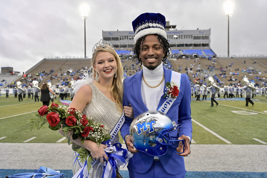 MTSU seniors Ashlee Dunn, left, of Jackson, Tenn., and Joshua Gray of St. Louis, Mo., were announced as Homecoming queen and king in Floyd Stadium on Saturday, Oct. 30, accepting their crowns from MTSU President Sidney A. McPhee and first lady Elizabeth McPhee. (MTSU photo by Andy Heidt)