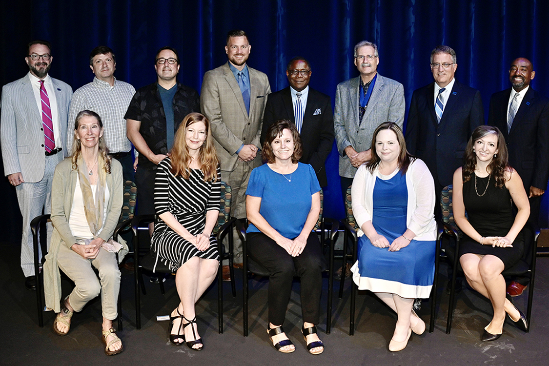MTSU faculty members gather for a group photo with university leaders Thursday, Aug. 19, after they were recognized by the MTSU Foundation with awards for their service at the 2021 Fall Faculty Meeting in Tucker Theatre. The recipients and their honors include, seated front row from left, biology professor Kim Cleary Sadler, Outstanding General Education Award; Meg Brooker of the Department of Theatre and Dance, Distinguished Creativity Award; Department of University Studies professor Dianna Z. Rust, Outstanding Teaching Award; Amy Elleman of the Department of Elementary and Special Education, Distinguished Research Award; and psychology professor Tiffany D. Rogers, Outstanding Teaching Award. Standing from left are University Honors College Associate dean and English professor Philip E. Phillips, Distinguished Research Award; finance professor Keith Jacks Gamble and Frank P. Lambert of the Womack Educational Leadership Department, Outstanding Achievement in Instructional Technology Awards; criminal justice administration professor Ben Stickle, Distinguished Research Award; MTSU President Sidney A. McPhee; Career Achievement Award winner Timothy Graeff of the Department of Marketing; MTSU Provost Mark Byrnes; and alumnus and MTSU Foundation Vice President Ronald Roberts. Not pictured is recording industry professor Odie Blackmon, who received an Outstanding Teaching Award. Details on each of the professors’ accomplishments are available at http://ow.ly/rcYE30rRunA. (MTSU photo by Andy Heidt)