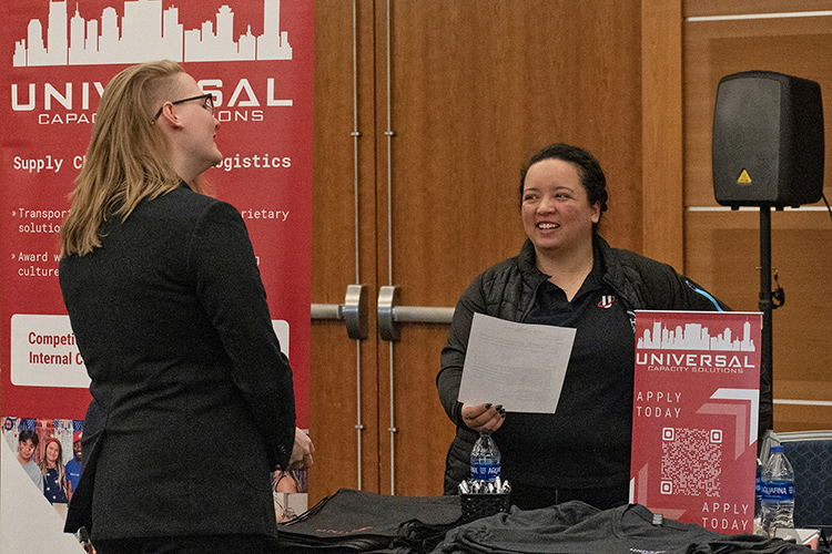 A representative with University Capacity Solutions, rights, chats with an MTSU student Tuesday, March 21, at the 2023 Business Exchange for Student Talent, or BEST, Career Fair inside the Student Union Ballroom. (MTSU photo by Darby Campbell-Firkus)