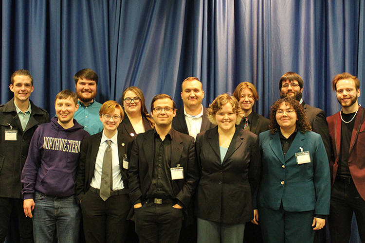 Members of the Blue Raider Debate Team pose for a photo at the International Public Debate Association National Tournament held in March in Boise, Idaho. Shown on the front row are, from left, MTSU alumnus Alex Fingeroot, a former national champion, and MTSU debate team members Elliot Certain, Graham Christophel, Link Williams and Marah Chance. On the back row are debate team members Ethan Schmidt, Jonny Locke, Jessica Rogers, Joey Mego, L.B. Boardwine, Derek Dismukes and Steven Barhorst. (Submitted photo)
