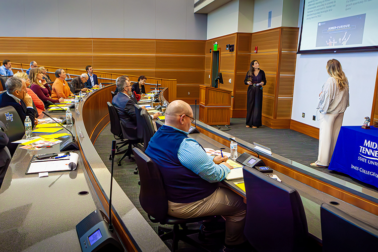 Fall 2022 MTSU graduate Jamie George, of Portland, Tenn., standing left, and her friend and business partner Haley Harris of Phoenix, Ariz., right, present their business plan for Like a Virgin Sober Bar before a panel of community judges April 26 during the 2023 Business Plan Competition Finals in the Student Union Parliamentary Room at Middle Tennessee State University. The duo won third place and $5,000. (MTSU photo by Tom Beckwith)