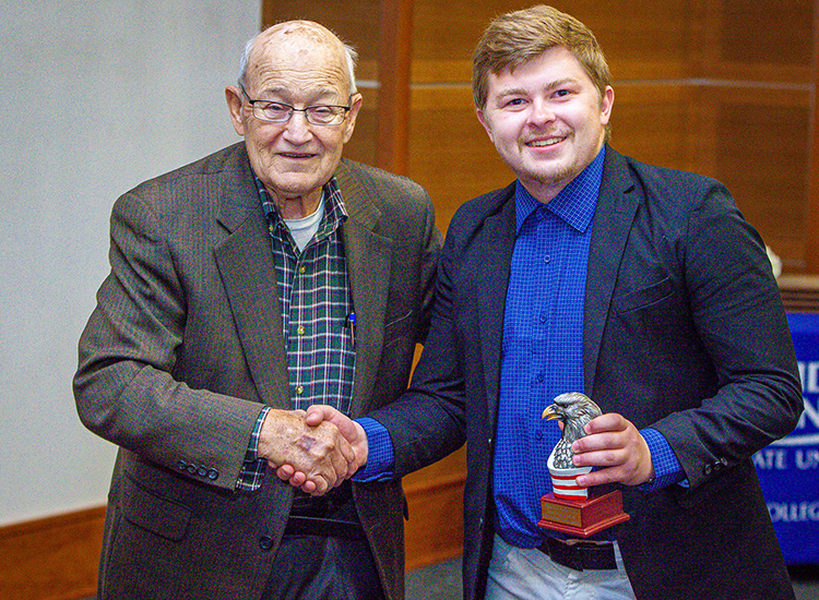 MTSU rising senior Britton Cherry of Mt. Juliet, Tenn., right, accepts the Robert and Virgie Clouse Agricultural Entrepreneurial Spirit Award from Wil Clouse, founder-president of The Clouse-Elrod Foundation Inc., at the 2023 Business Plan Competition Finals held April 26 in the Student Union Parliamentary Room at Middle Tennessee State University. The award comes with a $600 grant. As an honorable mention finalist, Cherry also earned a $2,000 prize for his plan for Good Samaritan Hauling and Labor. (MTSU photo by Tom Beckwith)