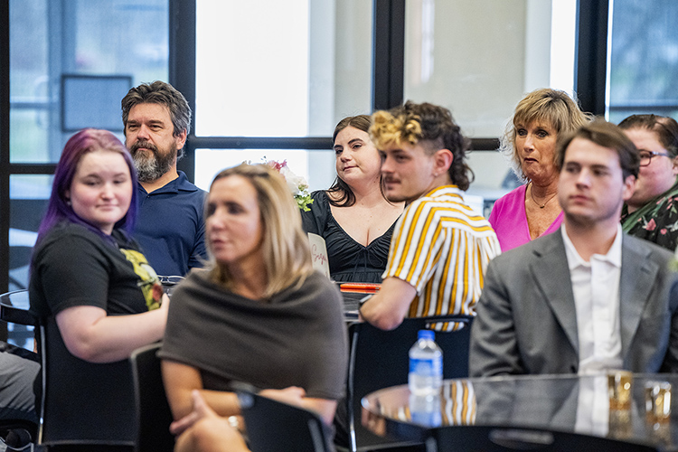 2023 Future Trailblazer Award recipient and senior Hayden “Gracie” Sizemore, back center in black, director of the MTSU School of Journalism and Strategic Media, looks on during the March 1 National Women’s History Month kickoff event inside that Ingram Building’s MT Center at Middle Tennessee State University. (MTSU photo by Andy Heidt)