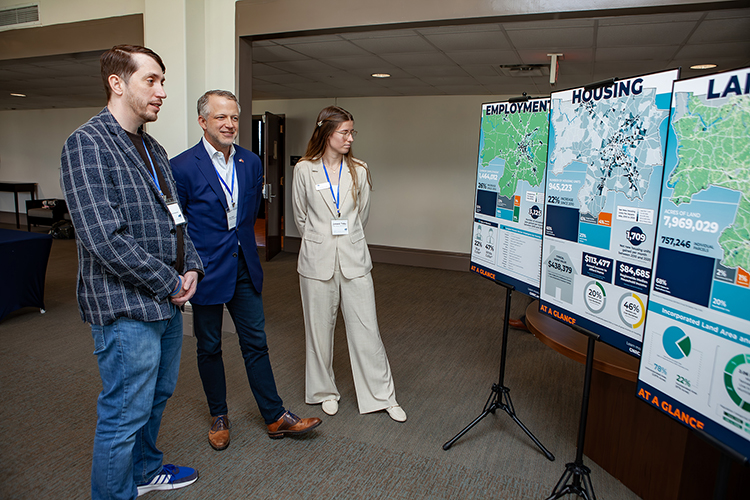 Attendees at Middle Tennessee State University’s annual Forum on Growth and Regional Challenges held Friday, March 21, inside the James Union Building Tennessee Ballroom on campus in Murfreesboro, Tenn., review a series of charts by the Greater Nashville Regional Council about the area’s employment, housing and land area. (MTSU photo by Tom Beckwith)