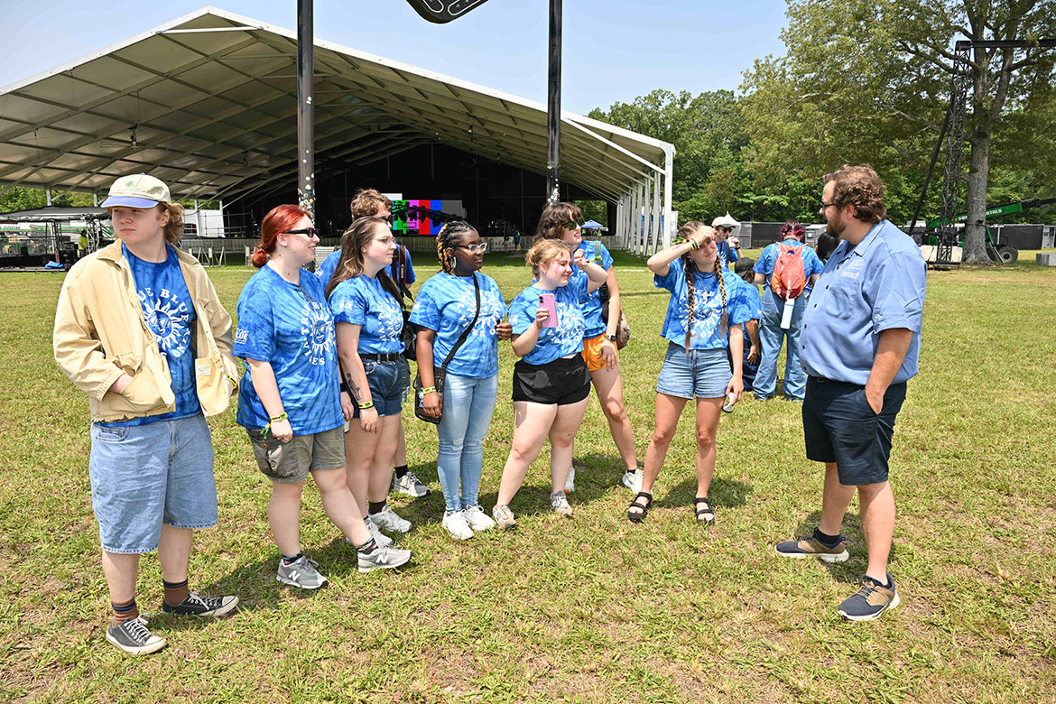 Matthew Leimkuehler, right, assistant journalism professor at Middle Tennessee State University in Murfreesboro, Tenn., gives instructions to the MTSU journalism students Wednesday, June 11, at the Bonnaroo Music and Arts Festival in Manchester, Tenn. Leimkuehler is supervising the students working as part of the Seigenthaler News Service to write stories and take photos from the festival that will be shared with media outlets statewide. (MTSU photo by James Cessna)