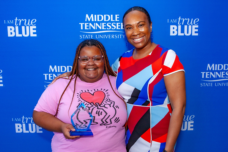 Middle Tennessee State University student Farrah Renfroe, a pre-law political science major, holds the inaugural Scholars Academy Award presented by Michelle Arnold, associate vice provost of Student Success, at the University College Awards ceremony held May 1 at the Miller Education Center atrium on the MTSU campus in Murfreesboro, Tenn. (MTSU photo by Tom Beckwith)