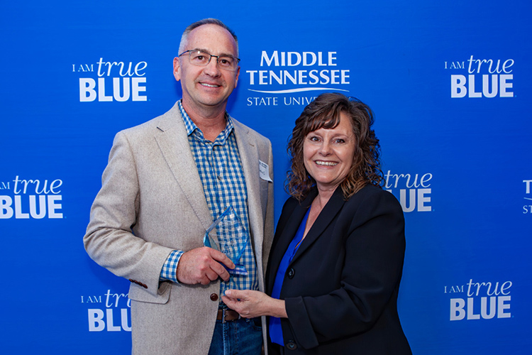 Middle Tennessee State University student James Rogers Jr., left holds the Outstanding Undergraduate Student Award he received at the University College Awards ceremony held May 1 at the Miller Education Center atrium on the MTSU campus in Murfreesboro, Tenn. At right is with Dianna Rust, University Studies professor. (MTSU photo by Tom Beckwith)