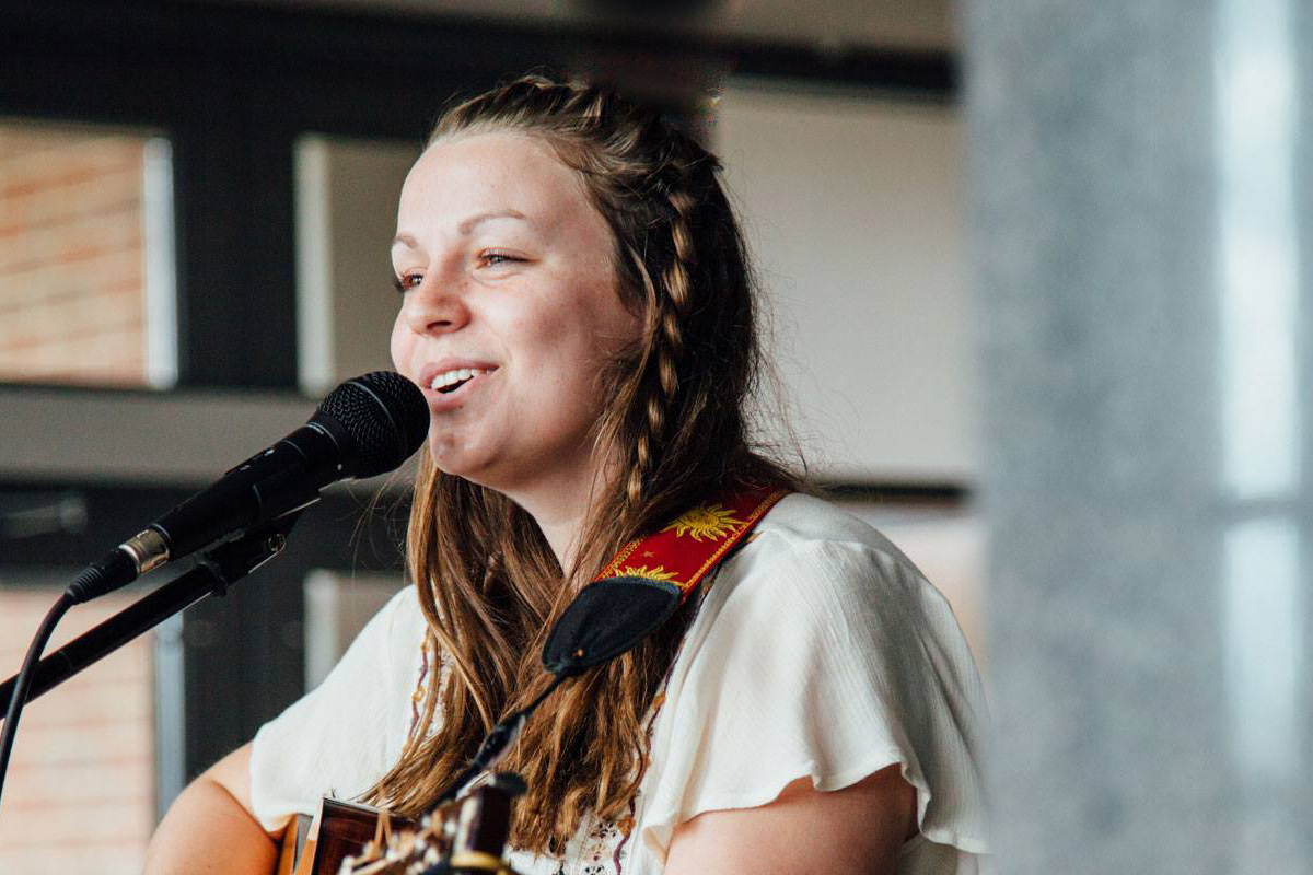 Jessica Yellowitz, a Commercial Songwriting major, sings and plays guitar in the MTSU Admissions Center on the Songwriters Stage