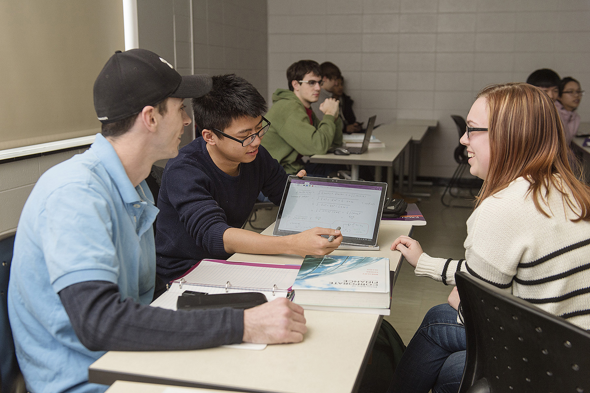 Mark Jackson, left, Wendi Chen and Allison Logan practice making their actuarial science presentations in professor Abdul Khaliq's mathematics of pricing theory class. The program is one of four internationally to receive the 2020 Casualty Actuarial Society University Award. (MTSU file photo by J. Intintoli)