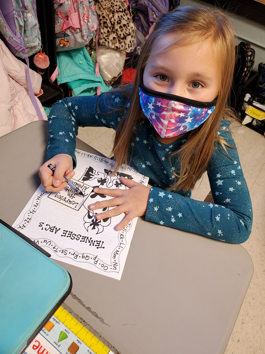 Campus School first grader Amelia Throneberry uses crayons on the coloring book that came with the Harvest Handbag — a gift from MTSU School of Agriculture agritourism class students to 80 youngsters at the Rutherford County School and MTSU teacher-training partner. (Submitted by Homer Pittard Campus School)