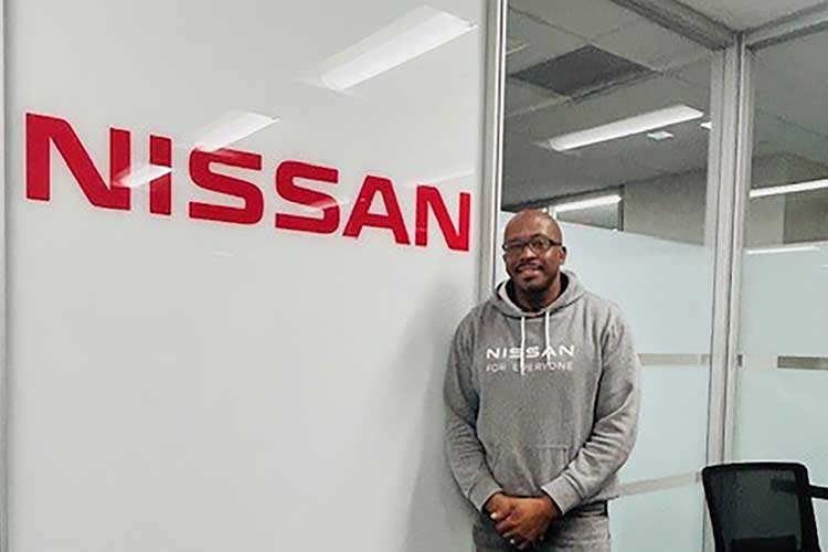 Antonio Fitts, pictured in front of the Nissan logo at the Nissan North America plant in Smyrna, Tenn., where he works in the workforce development department. Fitts is taking advantage of a partnership between the automaker and Middle Tennessee State University to earn a degree through the university’s Adult Degree Completion Program. (Submitted photo)