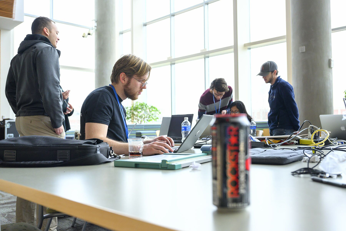 One of the teams in the fifth annual HackMT at MTSU collaborates to apply the finishing touches to its project just before the judged science fair portion of the event Sunday, Jan. 26, in the Science Building’s second-floor atrium. (MTSU photo by Cat Curtis Murphy)
