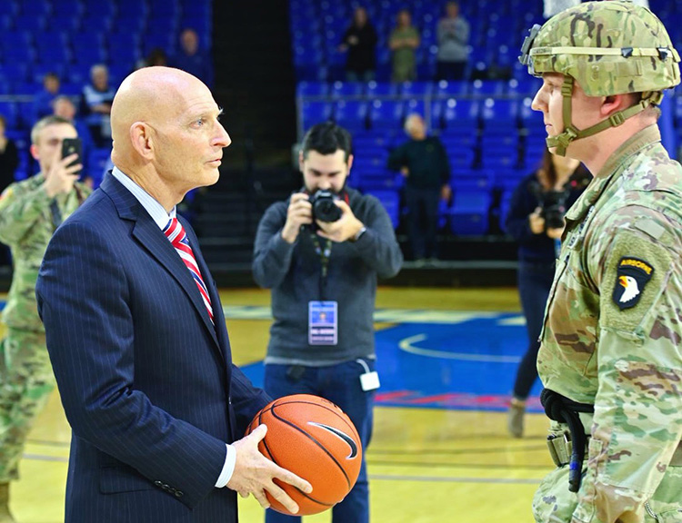 Retired Army Lt. Gen. Keith Huber, left, accepts the game ball from a member of the U.S. Army’s 101st Airborne Division after it was rappelled from the rafters onto the Hale Arena hardwood Jan. 30 as part of MTSU Women’s Basketball’s veteran appreciation night at Murphy Center. Huber, senior advisor for veterans and leadership initiatives at MTSU, spent nine years of his 38-year military career with the 101st. (MTSU photo by Cat Curtis Murphy)