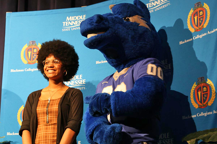 Lauryn Alston poses for a photo with MTSU mascot Lightning after sharing the topic of her Captsone project for the Blackman Collegiate Academy. (Photo by Mealand Ragland-Hudgins/Rutherford County Schools)