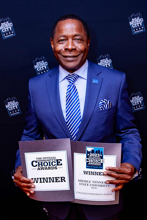 MTSU President Sidney A. McPhee displays the certificates given to the university in the 2023 Best of Music City Community’s Choice Awards. (Tennessean photo)