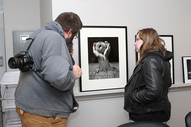 Attendees of the March 20 ribbon-cutting for the new Baldwin Photographic Collection and Archive view some of the prints on display in the archive’s reading room area on the second floor of the Miller Education Center on Bell Street. (MTSU photo by James Cessna)