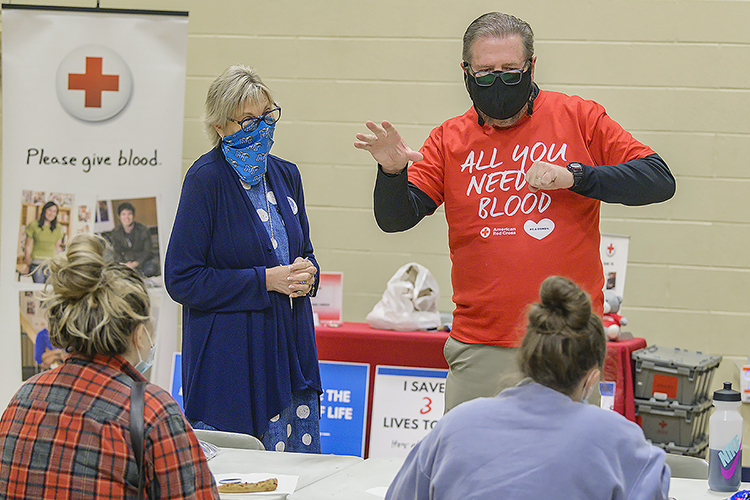 Ray Wiley, right, MTSU Campus Recreation associate director, encourages volunteers at MTSU’s September 2020 “Bleed Blue to Beat the COVID-19 Blues” blood drive while Senior Associate Athletic Director Diane Turnham, left, listens at the orth Boulevard Church of Christ gymnasium. Wiley and Turnham, both longtime American Red Cross blood donors, also are part of the university's annual Bleed Blue blood drive committee. MTSU's 2021 