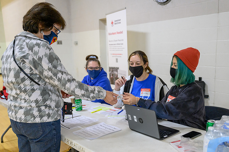 Nancy Pardy of Murfreesboro, left, presents her blood donor information card to MTSU student volunteer Abi Kelly, right, of Cottontown, Tenn., a junior computer science major, on Monday, Nov. 1, on the first day of the university's annual three-day "True Blue Blood Drive" in the Student Health, Wellness and Recreation Center. Looking on are student volunteers Jessica Hinger, center left, of Nolensville, Tenn., a freshman marketing and professional selling major, and Brittany Gilbert of Lyles, Tenn., a senior psychology major. With help from donors and volunteers like these, the American Red Cross-sponsored event collected 362 units of blood for the community, surpassing its 300-unit goal by 121%, and welcomed 152 first-time blood donors. (MTSU photo by J. Intintoli)