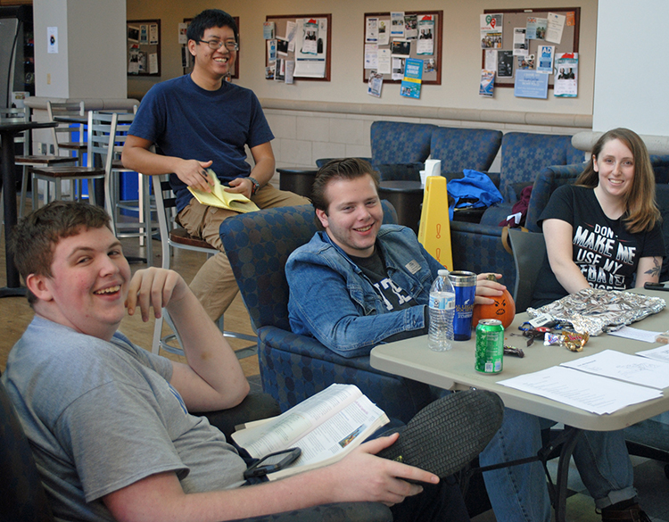 MTSU debaters Nick Ged, left, Steven Barhorst and Jordan Nickell share some off-stage time with a competitor from the University of Tennessee-Knoxville, who is seated behind them. Nickell’s T-shirt reads “Don’t make me use my debate voice.” This year’s “Blue Raider Debate Team” is in a rebuilding phase and is looking forward to several competitions and events this spring. (Photo submitted)