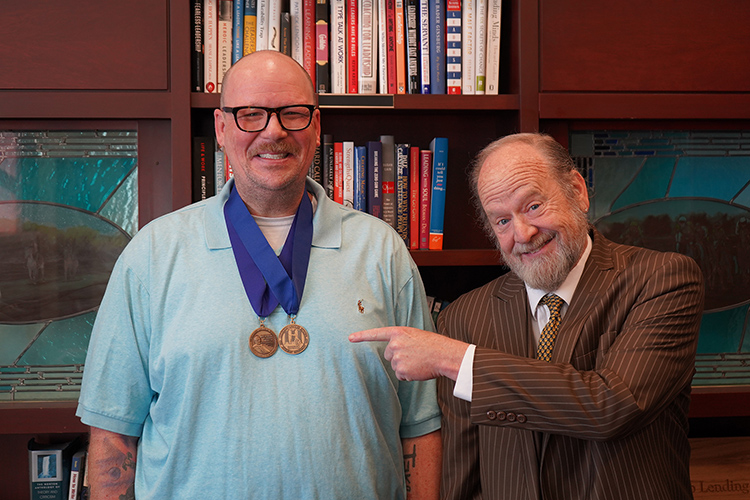 Middle Tennessee State University senior media arts major and Honors College student Brian Maxwell, left, is all smiles with media arts lecturer Leland Gregory, Maxwell’s thesis director, after Maxwell successfully defended his thesis on Nov. 13, 2023. (MTSU photo by Connie Bartemus)