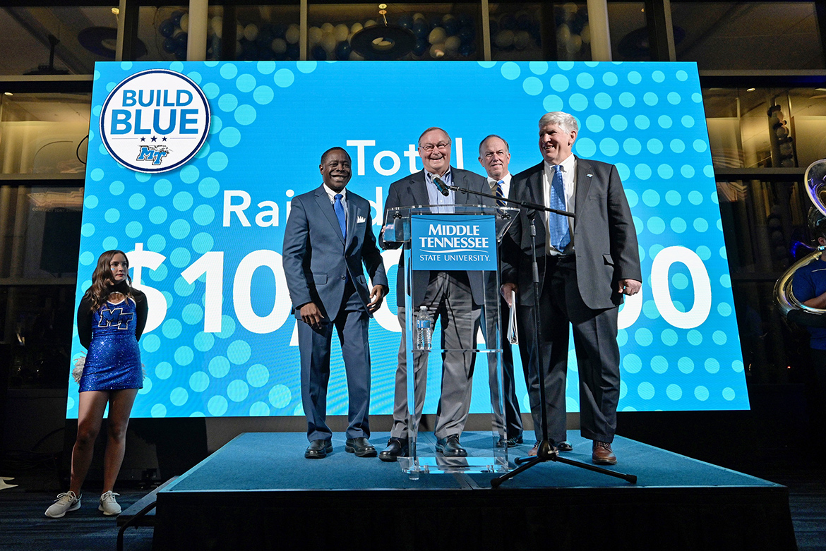 From left, MTSU President Sidney A. McPhee; alumnus and Blue Raider Athletic Association representative Andy Womack; Steve Smith, MTSU Board of Trustees chairman; and MTSU Athletic Director Chris Massaro pause for a photo Monday, Nov. 15, inside the Kennon Hall of Fame building during the university’s announcement of its Build Blue Now campaign to invest $100 million for upgrades to athletic facilities. (MTSU photo Andy Heidt)