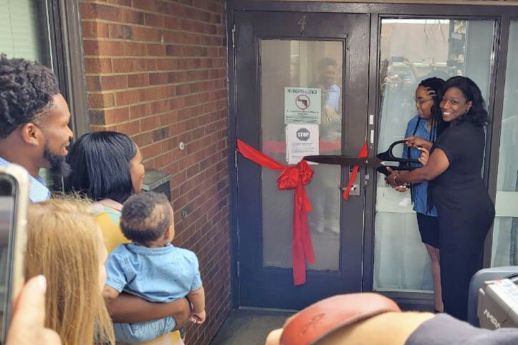 MTSU alumna Shatina Marshall, far right, resource linkage coordinator for the Tennessee Department of Children’s Services, prepares to cut the ribbon at the August ribbon-cutting ceremony for the renovated Resource Linkage Office in Nashville, Tenn. The office temporarily houses children and youth entering Davidson County foster care system each year. The renovations were paid for by MTSU alumnus and Tennessee Titans safety Kevin Byard and wife Clarke, looking on at left, through their Byard Family Legacy Fund. (Submitted photo)