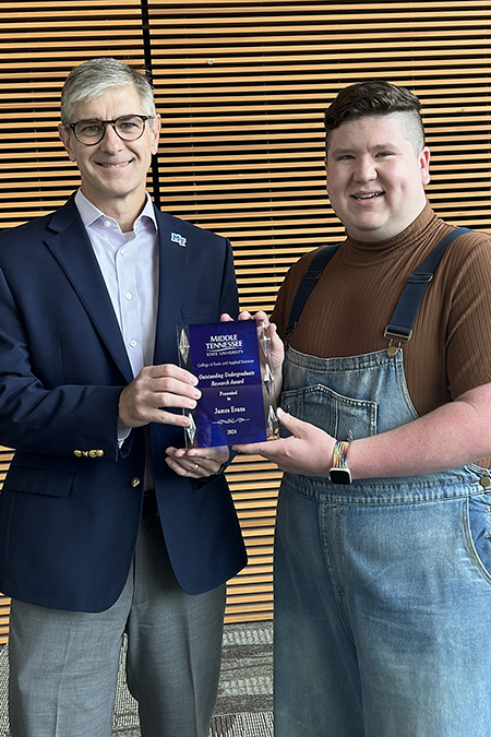 James Evans, Middle Tennessee State University recent graduate with a degree in biology, receives the College of Basic and Applied Sciences’ Outstanding Undergraduate Research Award from Dean Greg Van Patten in June 2024 at the MTSU Science Building in Murfreesboro, Tenn. (Submitted photo)