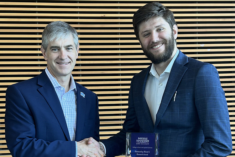 Joseph May, Middle Tennessee State University recent graduate with a master’s in computer science, receives the College of Basic and Applied Sciences’ Outstanding Masters Research Award from Dean Greg Van Patten in June 2024 at the MTSU Science Building in Murfreesboro, Tenn. (Submitted photo)