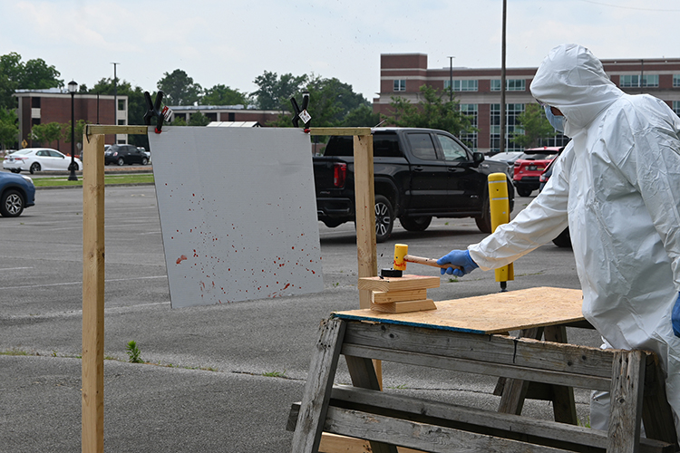 Middle Tennessee State University adjunct instructor and Murfreesboro Police Lt. James Abbott shows high school students attending the CSI:MTSU camp different blood spatter patterns during a blood spatter analysis demonstration on the MTSU campus in Murfreesboro, Tenn. Hosted June 3-6 by MTSU’s Forensic Institute for Research and Education, the camp gave the young students an in-depth look at the forensic science career field. (MTSU photo by Jordan Reining)